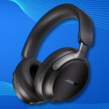 black bose quietcomfort ultra headphones on a blue background with soundwaves across the top and bottom