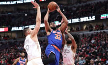 Karl-Anthony Towns #32 of the New York Knicks shoots the ball over Nikola Vucevic #9 of the Chicago Bulls during the first quarter at the United Center on January 4, 2025 in Chicago, Illinois.