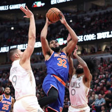 Karl-Anthony Towns #32 of the New York Knicks shoots the ball over Nikola Vucevic #9 of the Chicago Bulls during the first quarter at the United Center on January 4, 2025 in Chicago, Illinois.