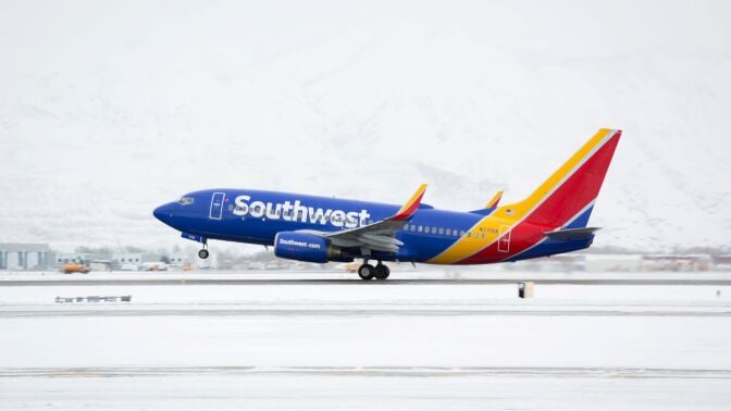 a southwest plane takes off on a runway in the snow