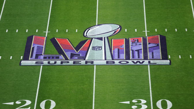 Super Bowl LVIII logo on the football field.