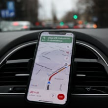 google maps on a phone attached to a dashboard