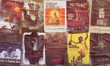 Ten posters for Australian horror films are pasted up on a wall.