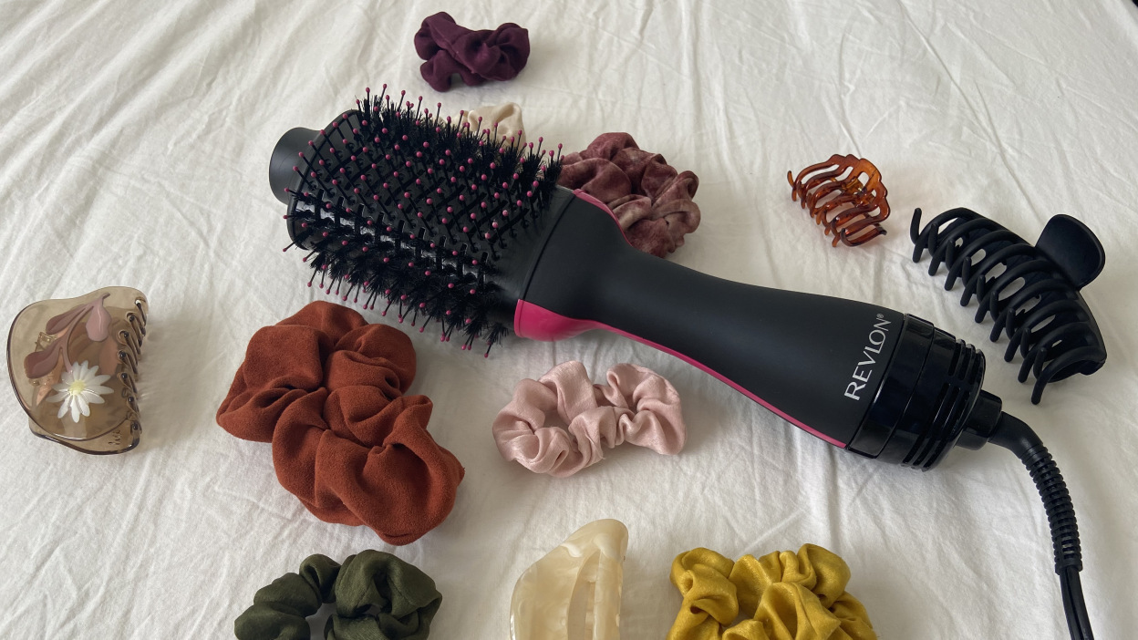 A Revlon One-Step surrounded by hair accessories.