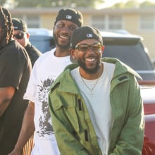 Kendrick Lamar smiles alongside Jay Rock, center, in between filming for the the music video for "Not Like Us" at Nickerson Gardens on Saturday, June 22, 2024 in Watts, CA.