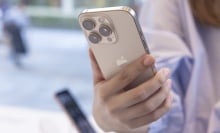 A customer holds the new Apple iPhone 16 Pro in her hand.