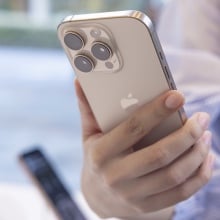 A customer holds the new Apple iPhone 16 Pro in her hand.