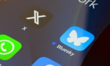 A close-up of a smartphone screen shows the X and Twitter logos.