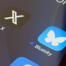 A close-up of a smartphone screen shows the X and Twitter logos.