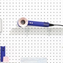 dyson supersonic on peg board among other supplies