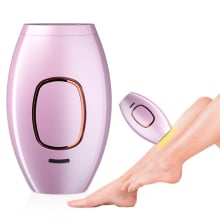 purple electronic laser hair removal device next to a shaved leg