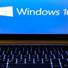 Windows 10 operating system logo is displayed on a laptop screen 