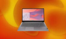 A Lenovo laptop appears on an orange, swirly abstract background.