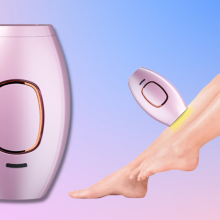 laser hair remover device next to hairless legs 