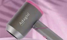 Adagio Accelerator 2100 Foldable Blow Dryer on a pink background.