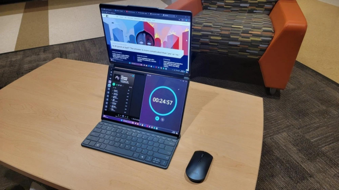 A Lenovo Yoga Book on a wooden desk