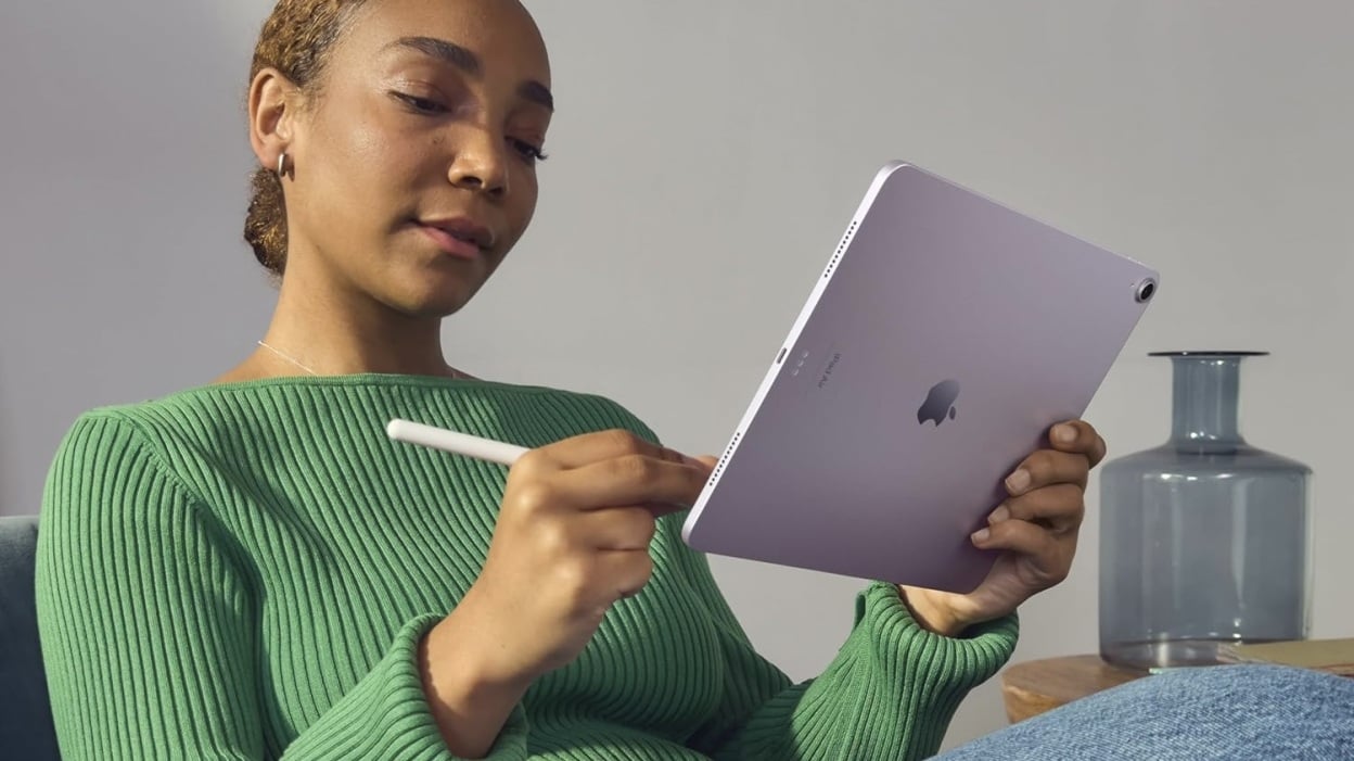 person in green sweater working on purple m2 ipad air with apple pencil