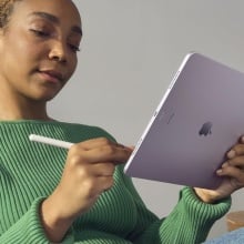 person in green sweater working on purple m2 ipad air with apple pencil