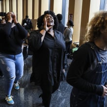 Choir members walk through an audience as they perform for We are Resilient: A Rally for George Floyd to celebrate his life. 