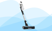 A white and black Levoit cordless stick vacuum cleaner against a blue background with stylized wave patterns.