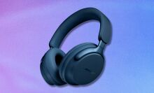 lunar blue bose quietcomfort ultra headphones on a purple and blue gradient background