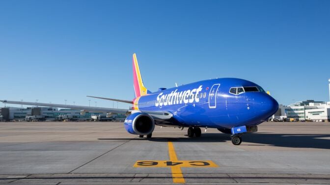 an angled side shot looking at a southwest airplane sitting on a runway