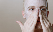 Person washing face with foam.