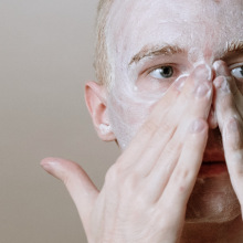 Person washing face with foam.