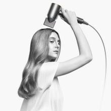 woman using the dyson supersonic hair dryer 