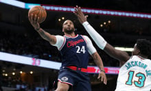 Norman Powell #24 of the LA Clippers goes to the basket against Jaren Jackson Jr. #13 of the Memphis Grizzlies during the second half at FedExForum on December 23, 2024 in Memphis, Tennessee. 