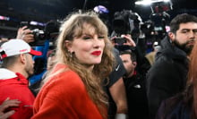 Taylor Swift in a red sweater on the field celebrating the Kansas City Cheifs' win.