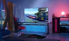 Samsung TV in room with colorful LED lights near gaming chair