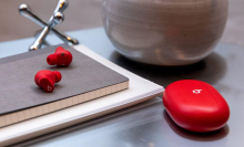 A pair of Beats Studio Buds on a desk.