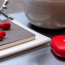 A pair of Beats Studio Buds on a desk.