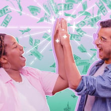 two people high fiving with money falling in the background