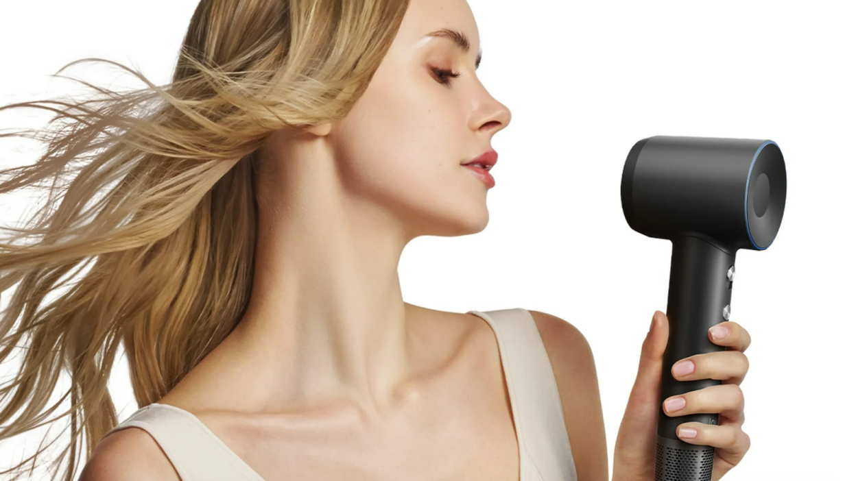 a woman holding the laifen swift hair dryer