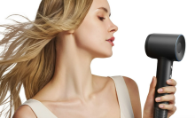 a woman holding the laifen swift hair dryer