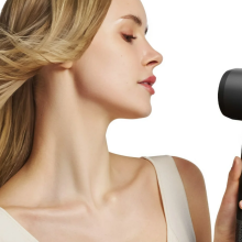 a woman holding the laifen swift hair dryer