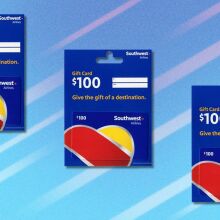 three $100 southwest airlines gift cards on a blue background