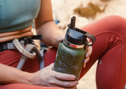 Rock climber holding HydroFlask