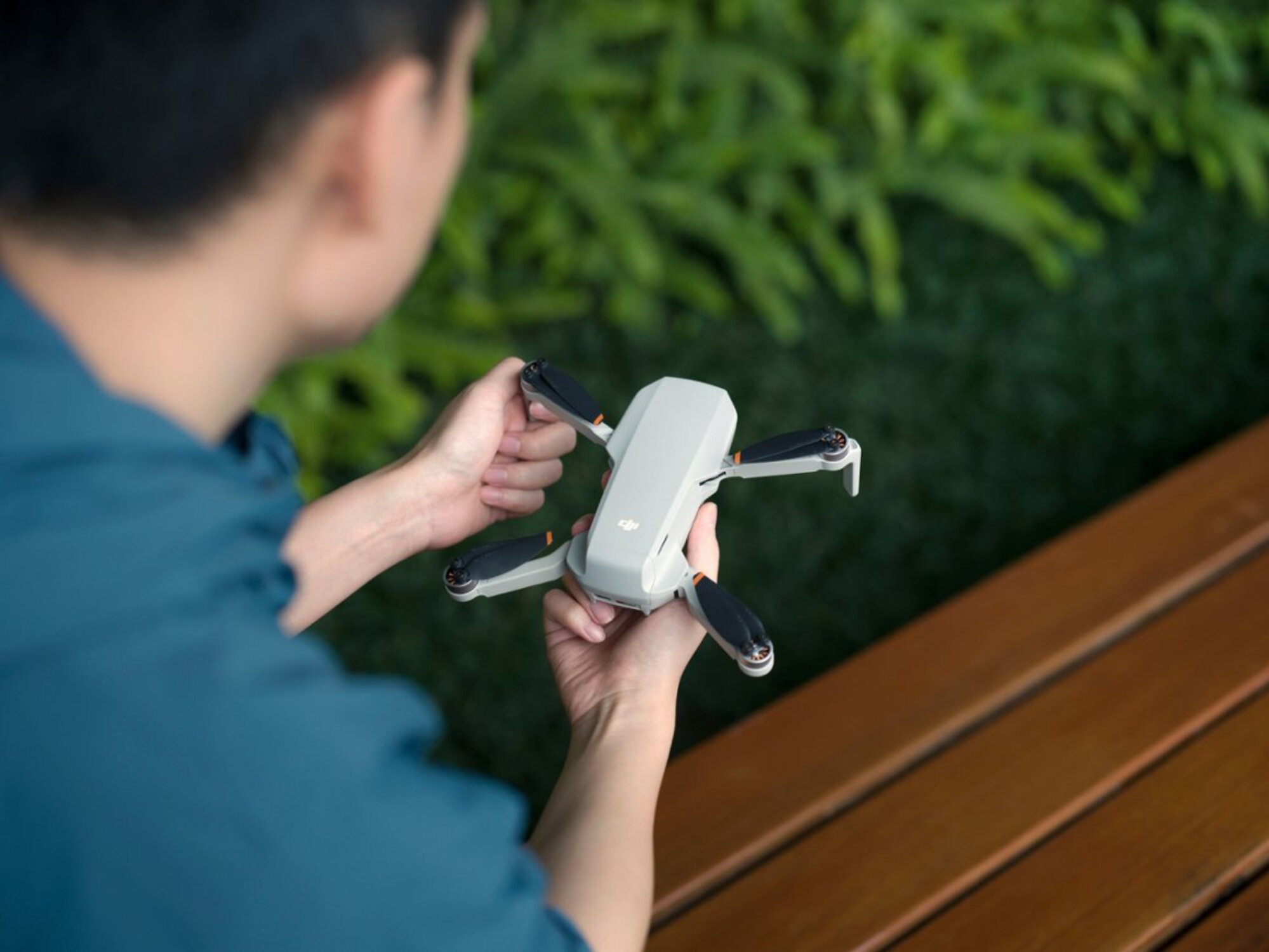 person holding DJI mini 2 SE drone