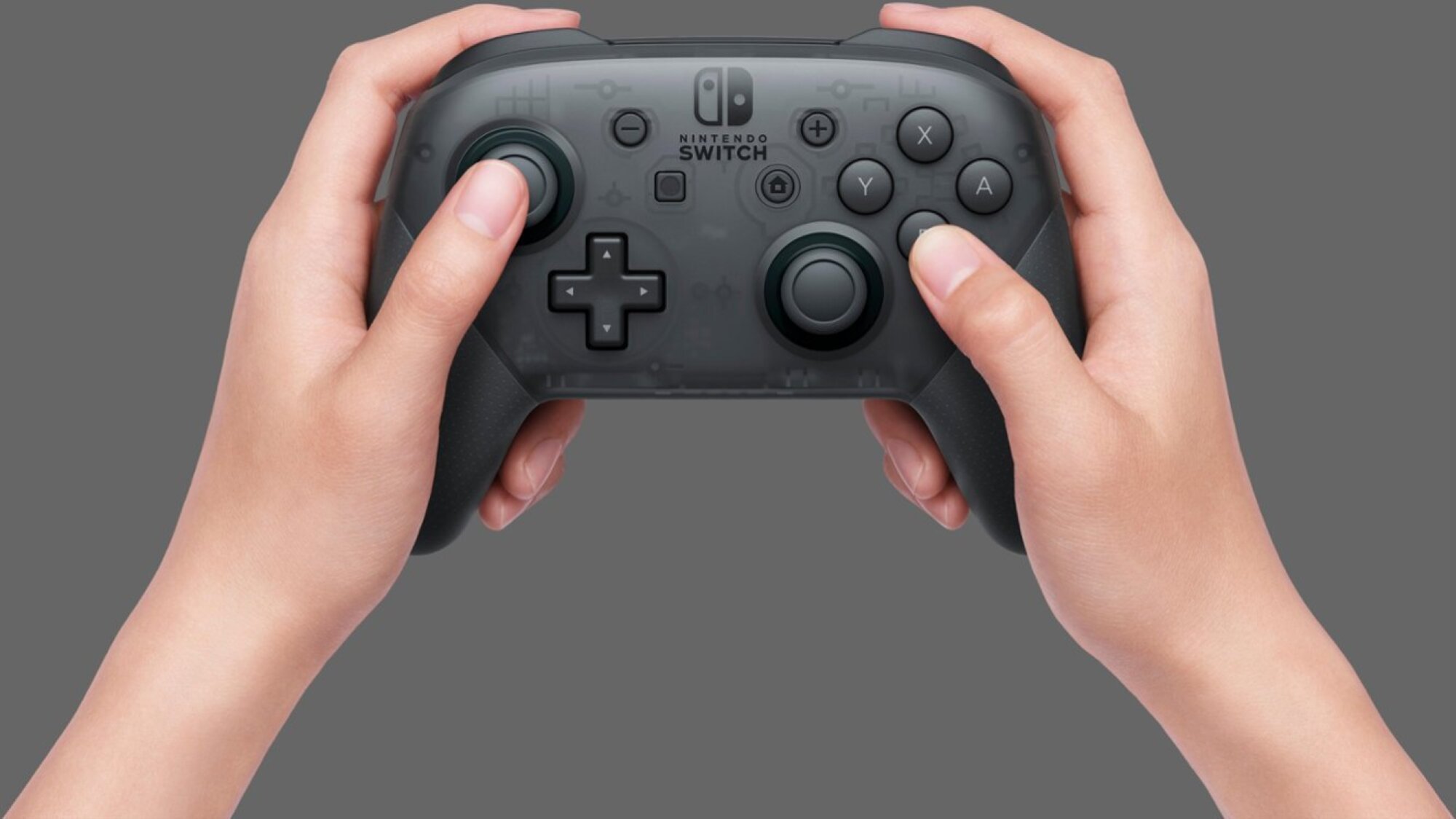 person holding black Nintendo Switch Pro controller