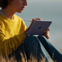 A kid uses the Apple iPad Mini