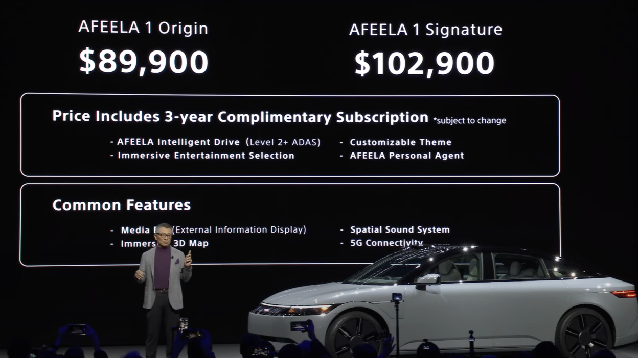 A presentation slide showcasing two AFEELA car models: "AFEELA 1 Origin" priced at $89,900 and "AFEELA 1 Signature" at $102,900. Both include a 3-year complimentary subscription with advanced features and common specifications like a 3D map and 5G connectivity. A car and presenter are visible in the foreground.