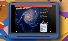 A blue children's tablet displays a page from an e-book titled "What's a Planet?". The page features a colorful image of a spiral galaxy, a short poem about planets, and a sidebar with definitions of space terms like "gas" and "star."