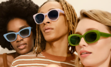 three women wearing sunglasses in light blue, light pink, and olive green