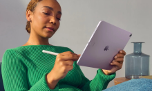 Person writing with Apple Pencil on purple iPad Air