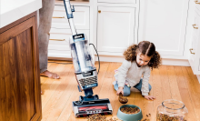 shark vacuum cleaning up dog food on hardwood floor 