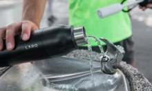 person filling up water bottle at drinking fountain