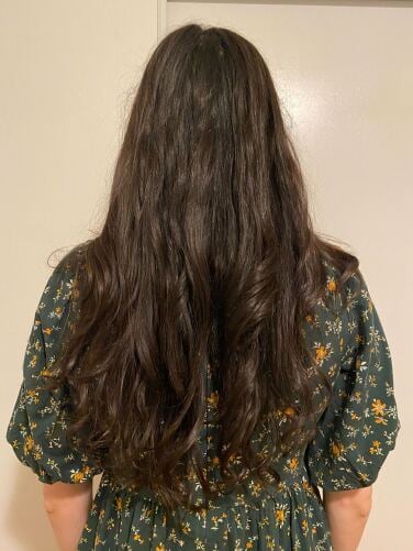 woman in green dress with curled hair